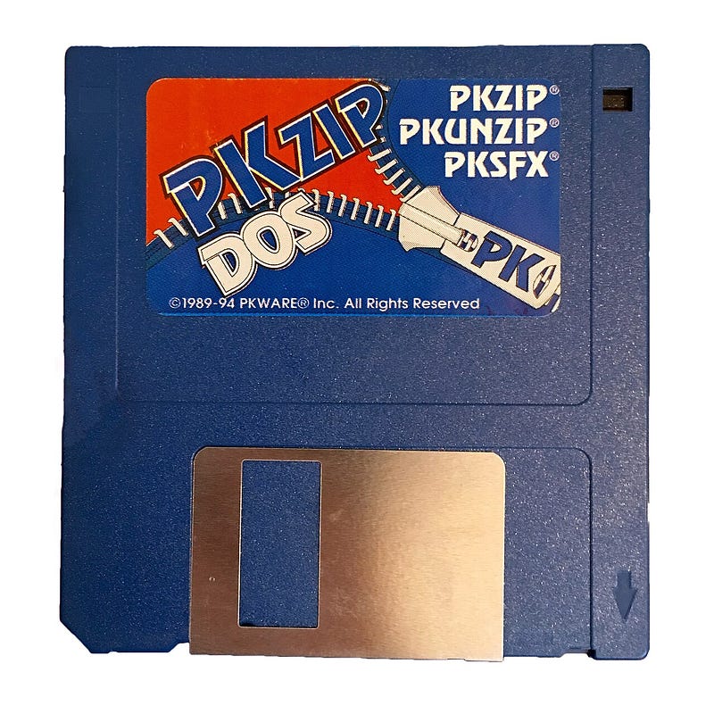A PKZIP for DOS distribution floppy, its label listing PKZIP, PKUNZIP and PKSFX