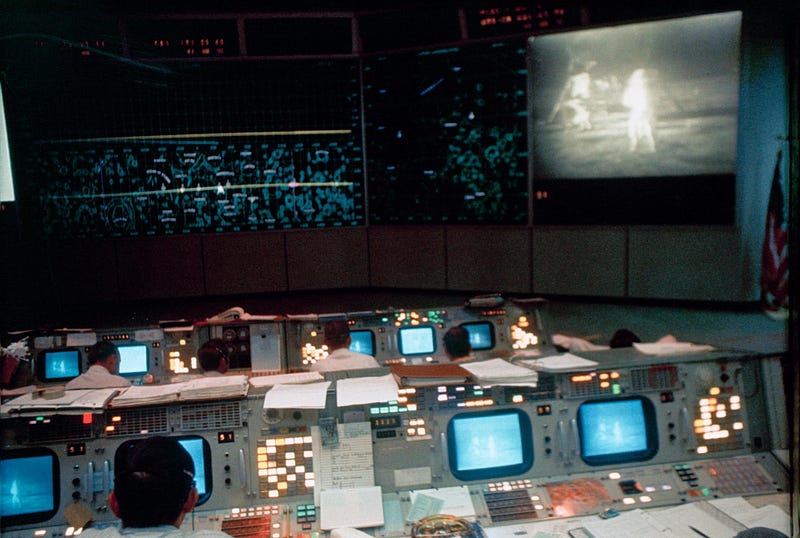 NASA Mission Control room during the Apollo 11 Moon landing, engineers watching the descent https://images-assets.nasa.gov/image/S69-39817/S69-39817~large.jpg